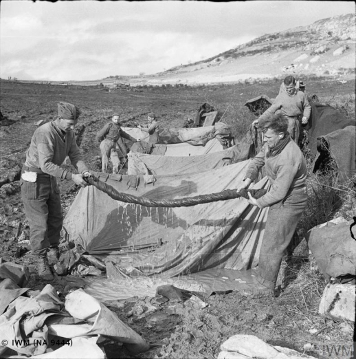THE CAMPAIGN IN ITALY, SEPTEMBER-DECEMBER 1943: THE ALLIED ADVANCE TO THE GUSTAV LINE (NA 9444) Monte Camino November - December 1943: Two artillerymen (Sergeant J Hamilton and Gunner H Tennant) wringing water out of a blanket at their flooded bivouac on Monte Camino. Copyright: © IWM. Original Source: http://www.iwm.org.uk/collections/item/object/205194461